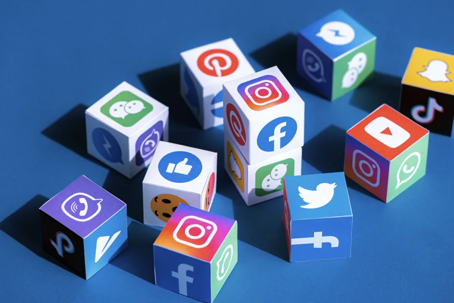 Scattered dice with social media icons on them