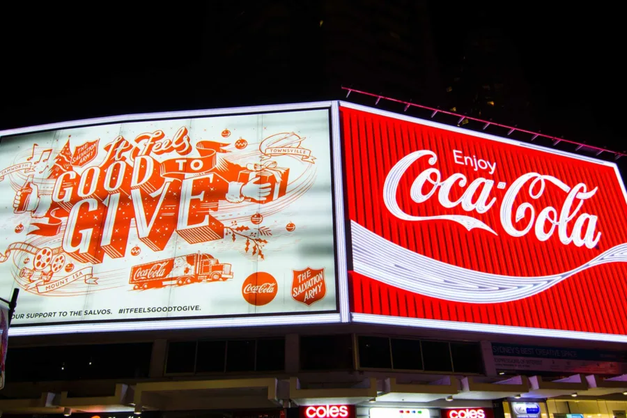 A digital billboard with Coca-Cola ads