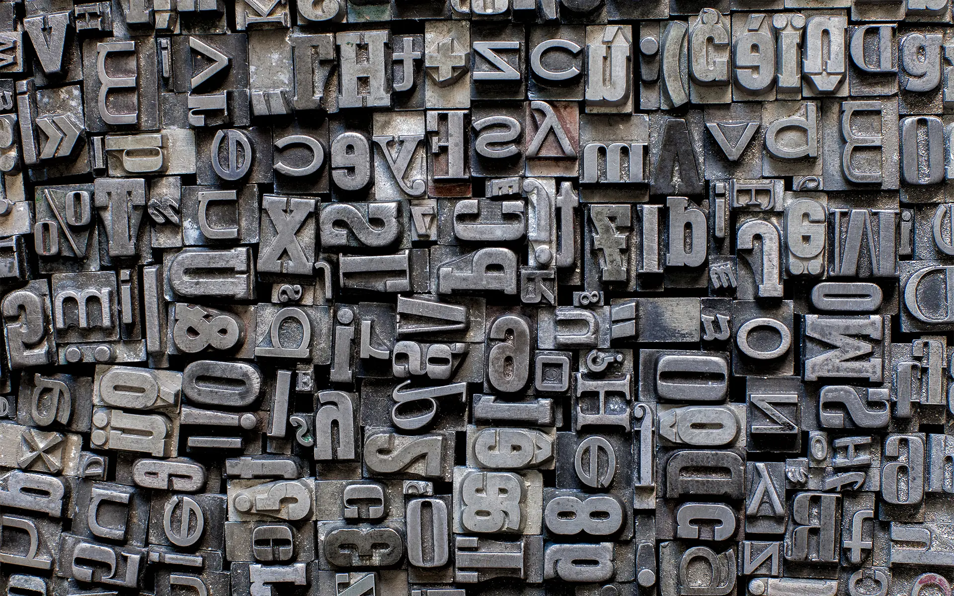 Various metal letters crowded together to create a background