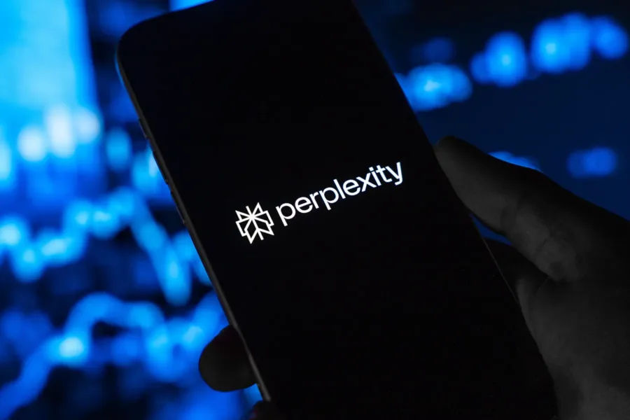 A close up image of an iPhone with the Perplexity logo on the screen