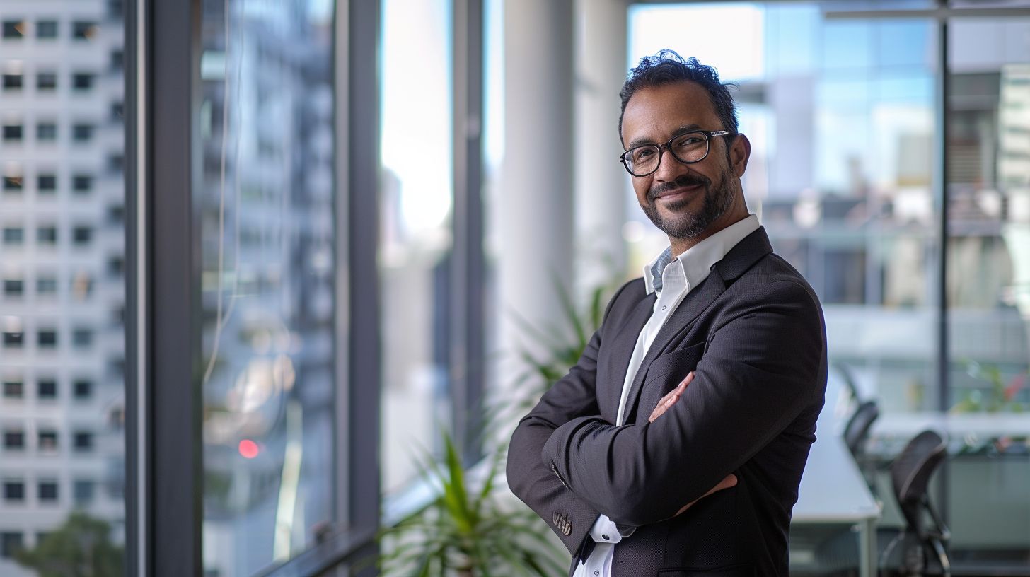 A confident professional in a modern office space with a cityscape backdrop. A confident professional in a modern office space with a cityscape backdrop.